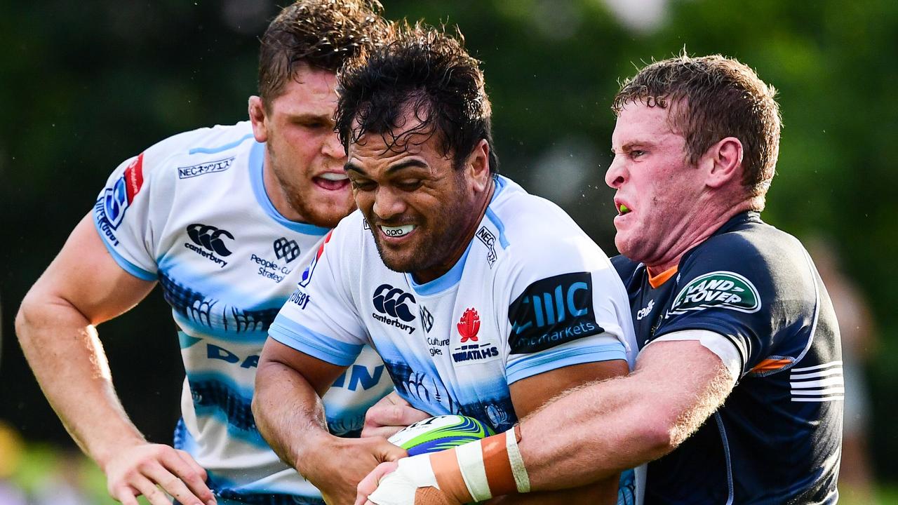 Karmichael Hunt is tackled by Tom Cusack in the Super Rugby trial in Goulburn.