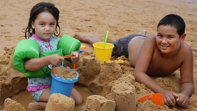 Bridie Smith, 3, and Raymond Smith, 10, from Narrabeen build sandcastles. Photo: Martin Lange