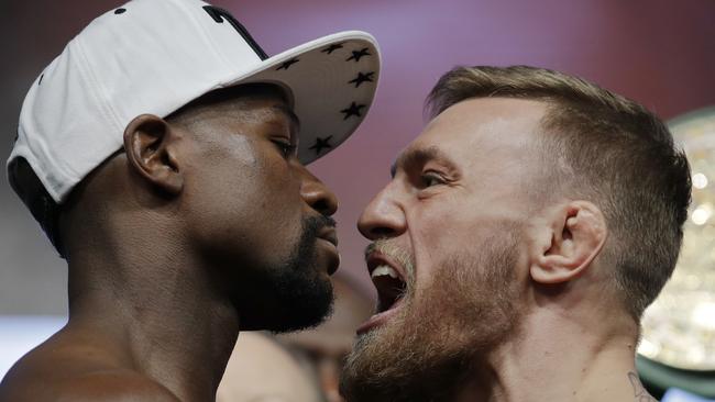 FILE — In this Friday, Aug. 25, 2017, file photo, Floyd Mayweather Jr., left, and Conor McGregor face off during a weigh-in in Las Vegas. The Mayweather-McGregor fight was one of the top searches on Google in 2017. (AP Photo/John Locher, File)