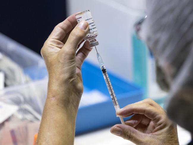 A nurse is seen drawing up doses from a multi-dose vile of AstraZeneca COVID-19 vaccine. Picture: Getty Images