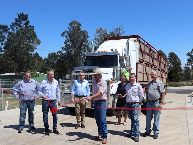 Local MP's Kevin Hogan and Chris Gulaptis, Council reps Crs Richie Williamson and Debrah Novak, Stock & Station Agent Ben Clarke, Vendor Bruce Finlay and truck driver Barry McKey look on as local Stock & Station Agent, Mitch Donovan does the honours and declares the new truck wash at the Grafton Saleyards open.