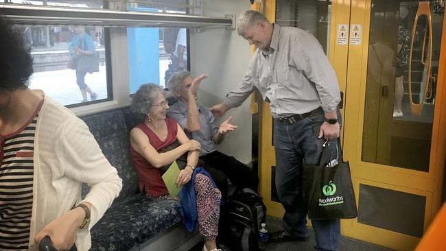 Rail, Transport &amp; Bus Union President Alex Claassens talks to passengers on a Sydney train. Picture: Linda Silmalis