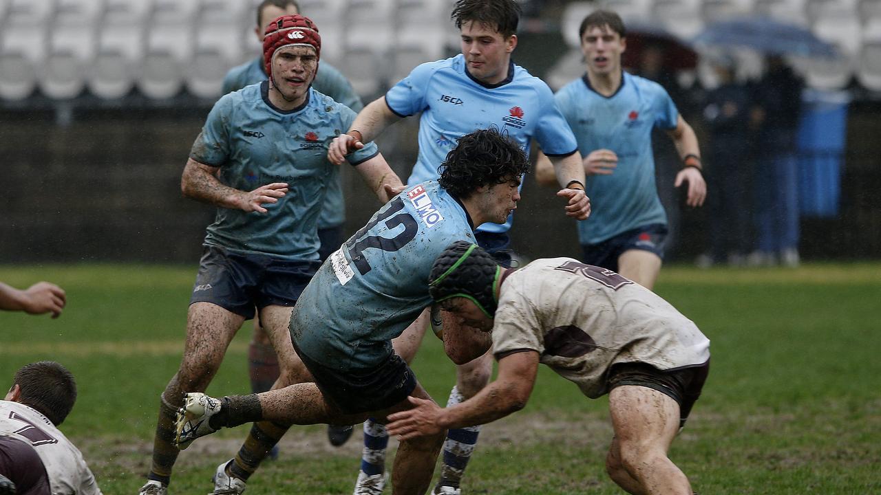 NSW's Leo Bassingthwaighte with the ball and being tackled by Queensland's Jakeb Horne at the 2022 Australian School Rugby Championships at Knox Grammar. Picture: John Appleyard