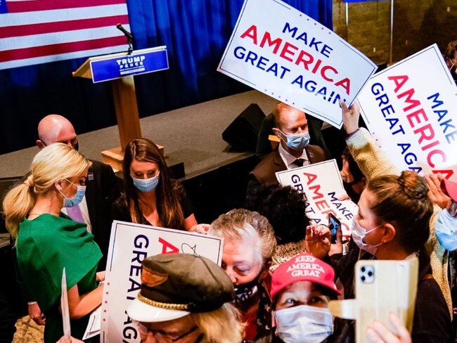 Ivanka signs merchandise for fans of the President.