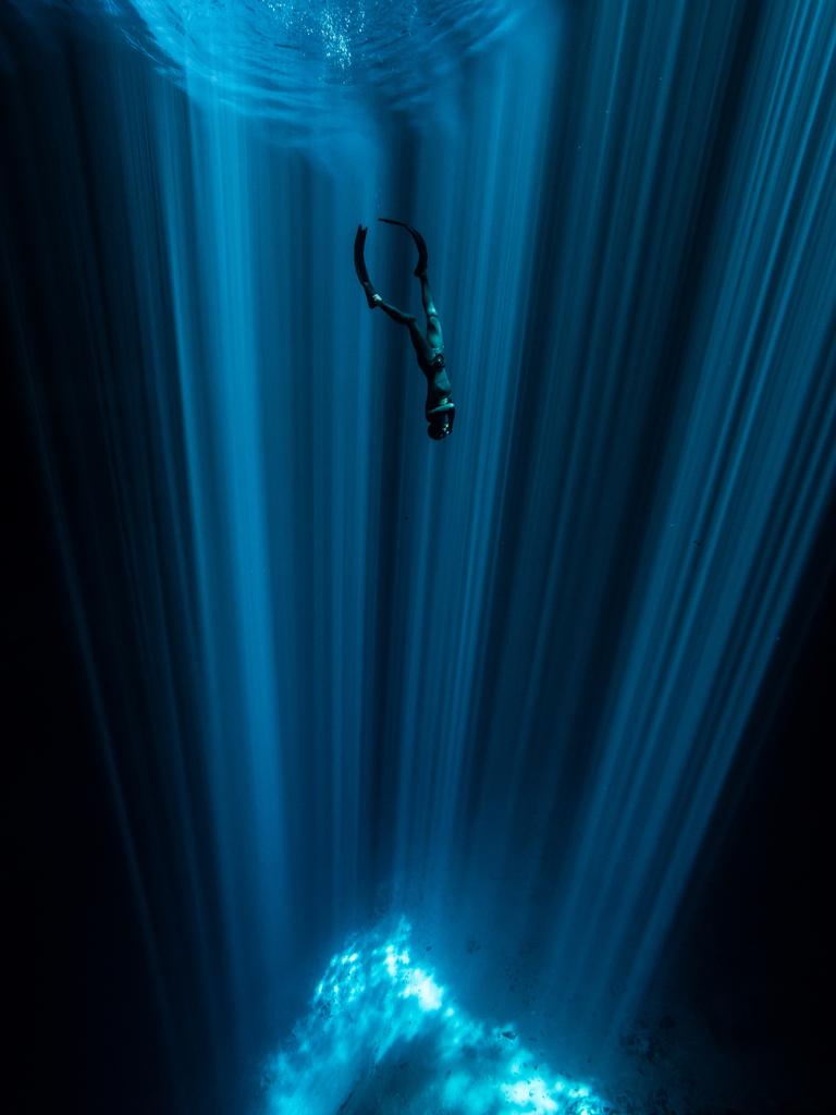 Underwater Photographer of the Year 2018. COMMENDED Category: Wide Angle Credit name: Wendy Timmermans/UPY 2018 Nationality: Netherlands. “This picture was taken with natural light and on one breath only, while freediving in the remote Cenote Nah Yah. A hypnotizing bundle of sunbeams lightened up the crystal clear water into the depths, contrasting with the darkness.”