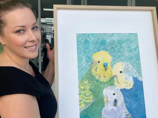 Townsville artist Leah Harris with her artwork titled 'Family', acrylic on canvas paper. The piece has been donated to a silent auction fundraising for multiple sclerosis agency MS Australia.