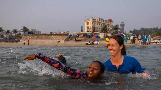 Emma McKeon joins a group of female swimmers and surfers in the water at Laboni Beach, Cox's Bazar, Bangladesh. Picture: Jason Edwards