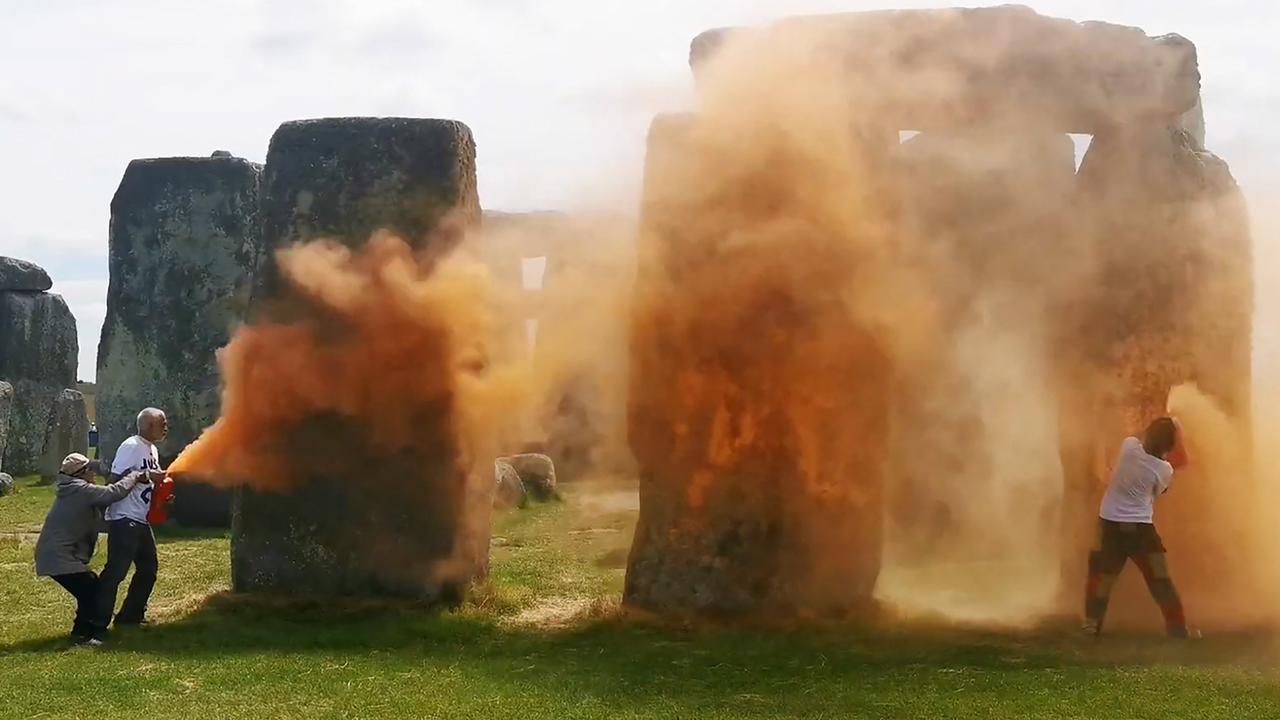 Just Stop Oil activists spraying an orange powder on Stonehenge. Picture: AFP