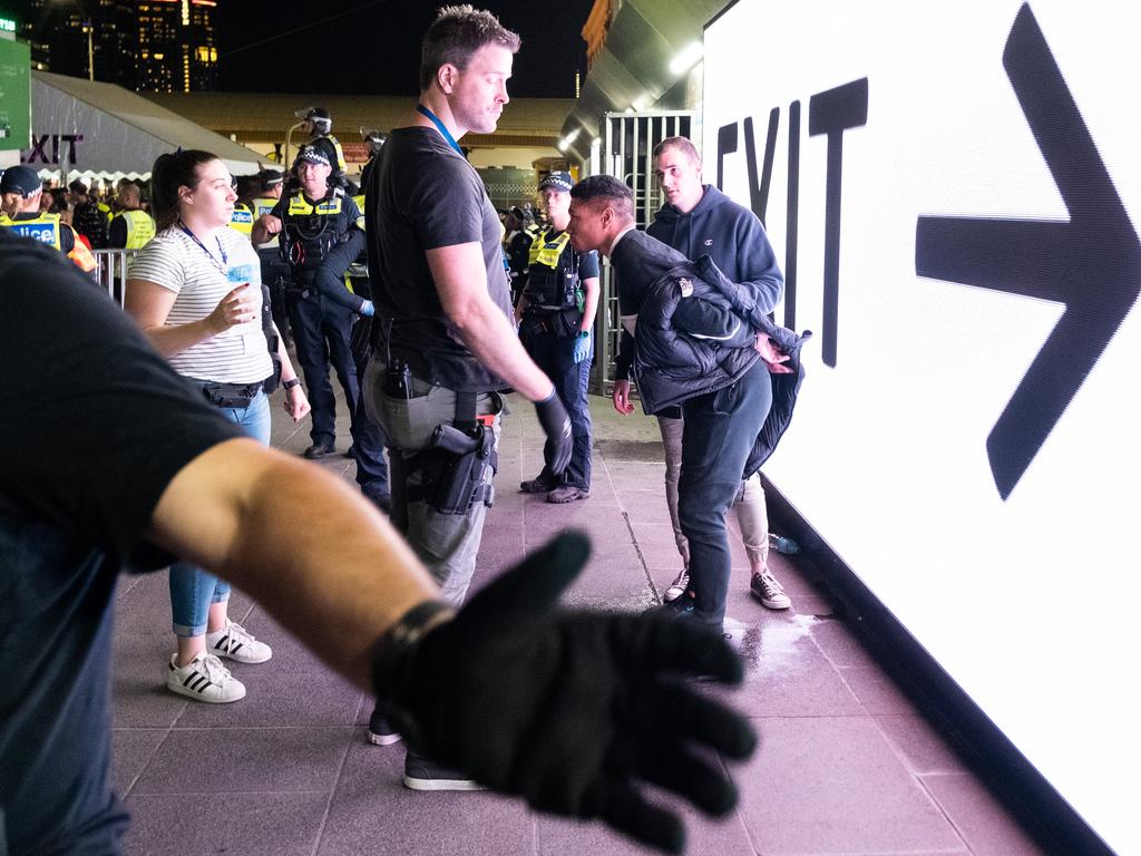 A man is held by plainclothes police in Melbourne after receiving treatment during New Year’s Eve just after midnight on 2020. Picture: Asanka Ratnayake/Getty