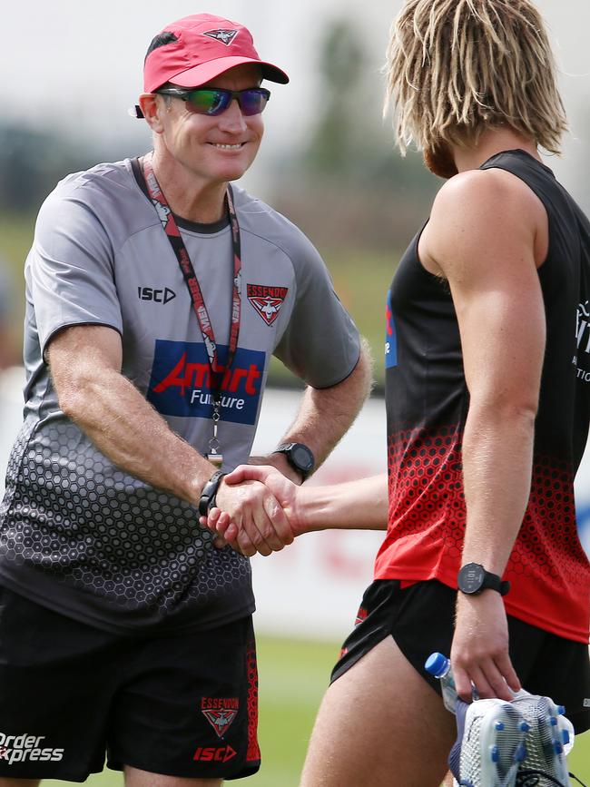 Coach John Worsfold welcomes captain Dyson Heppell back to Essendon training. Pic: Michael Klein