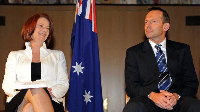 Not much between them ... a jubilant Prime Minister Julia Gillard with Opposition Leader Tony Abbott in Canberra. Picture: AFP