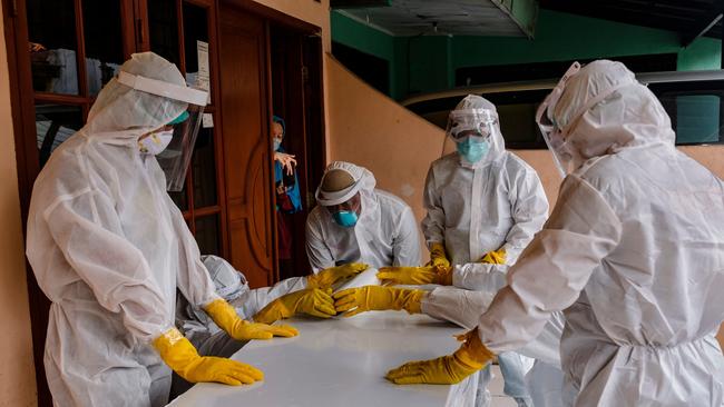 Public safety officers seal the casket of a man suspected to have died of Covid-19 in Jakarta on Tuesday. Picture: Getty Images