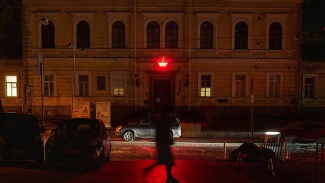 A woman walks through darkened Kyiv as many street lights remain off due to power shortages following Russian air strikes on the country's energy infrastructure. Picture: Spencer Platt/Getty Images