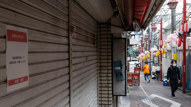 People walk past closed shops in Shinjuku district of Tokyo on Ma, during a coronavirus state of emergency covering Tokyo, Osaka, Kyoto and Hyogo regions. Picture: Yui Iawmura/AFP