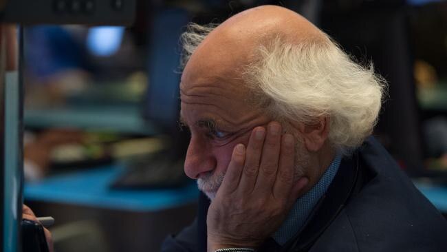 A Wall Street trader. Volatility in equity markets is at all-time lows. Pic: AFP