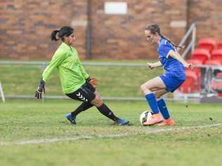 CALM ON THE BALL: Abbey Lloyd beats The Gap keeper Noran Abaza before going on to score. The former South West Queensland Thunder striker will face her old club when she lines up for Capalaba tomorrow. Picture: Kevin Farmer