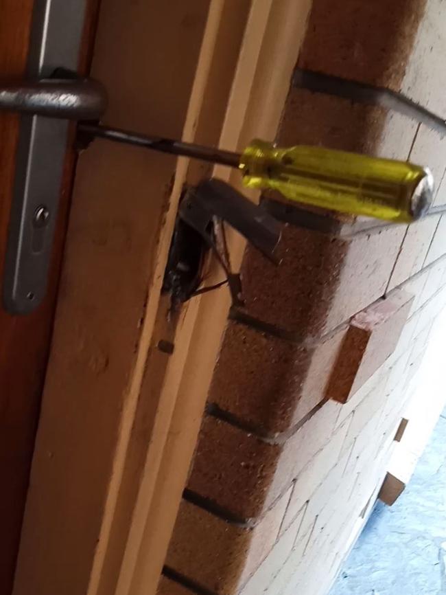 A still from the terrifying video of David Joseph Parker using power tools and a hammer and chisel trying to breakdown the front door. Picture: Supplied