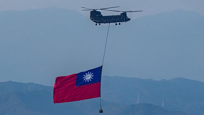 A CH-47 hoists a Taiwan flag fly across the city during a rehearsal ahead of Taiwan National Day celebrations on September 29 in Taipei. Picture: Getty Images