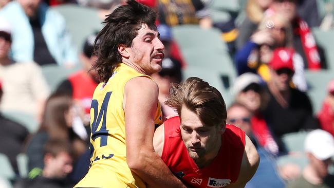 Lachlan Jones (left) lays a crunching tackle in the SANFL Grand Final.