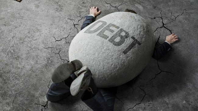 Trouble, debt, crisis concept, high angle view of a businessman crushed by the huge stone on the street generic