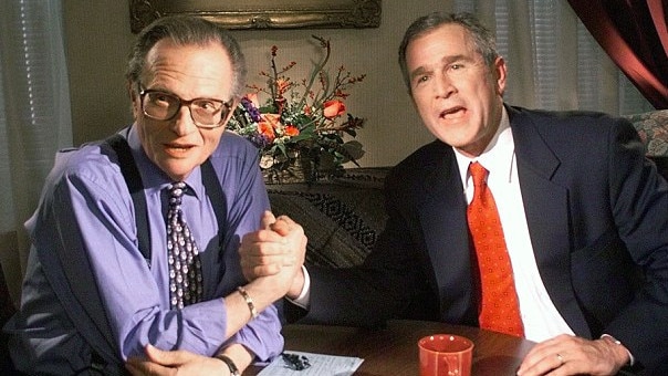 Then-US President George W Bush (right) shakes Larry King’s hand following an interview. Picture: Supplied