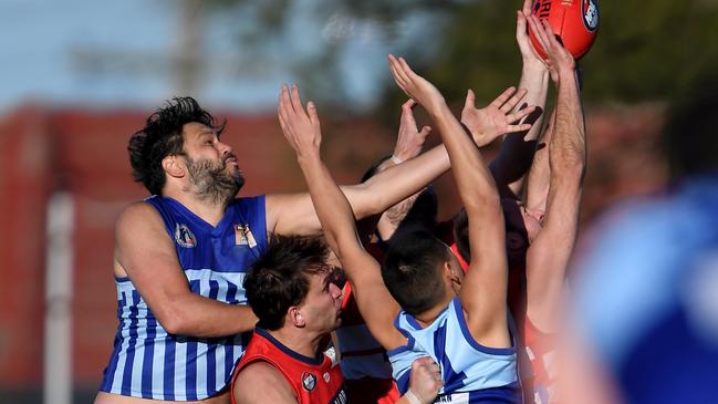 Reservoir and Lalor players fly for the mark. Picture: Andy Brownbill