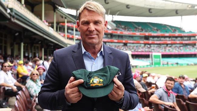 Shane Warne with the baggy green cap he auctioned to raise money for bushfire relief.