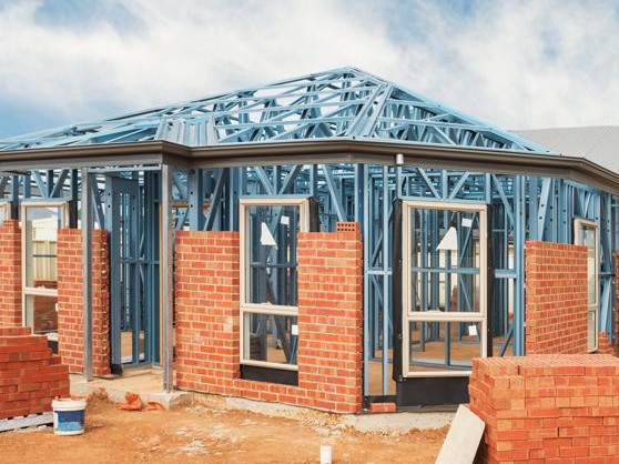 New residential construction home from brick with metal framing against a blue sky; real estate Australian generic suburban homes