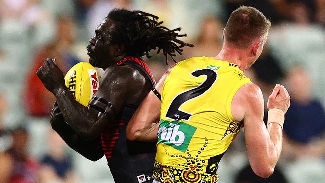 DARWIN, AUSTRALIA – AUGUST 22: Anthony McDonald-Tipungwuti of the Bombers is challenged by Dylan Grimes of the Tigers during the round 13 AFL match between the Essendon Bombers and the Richmond Tigers at TIO Stadium on August 22, 2020 in Darwin, Australia. (Photo by Daniel Kalisz/Getty Images)