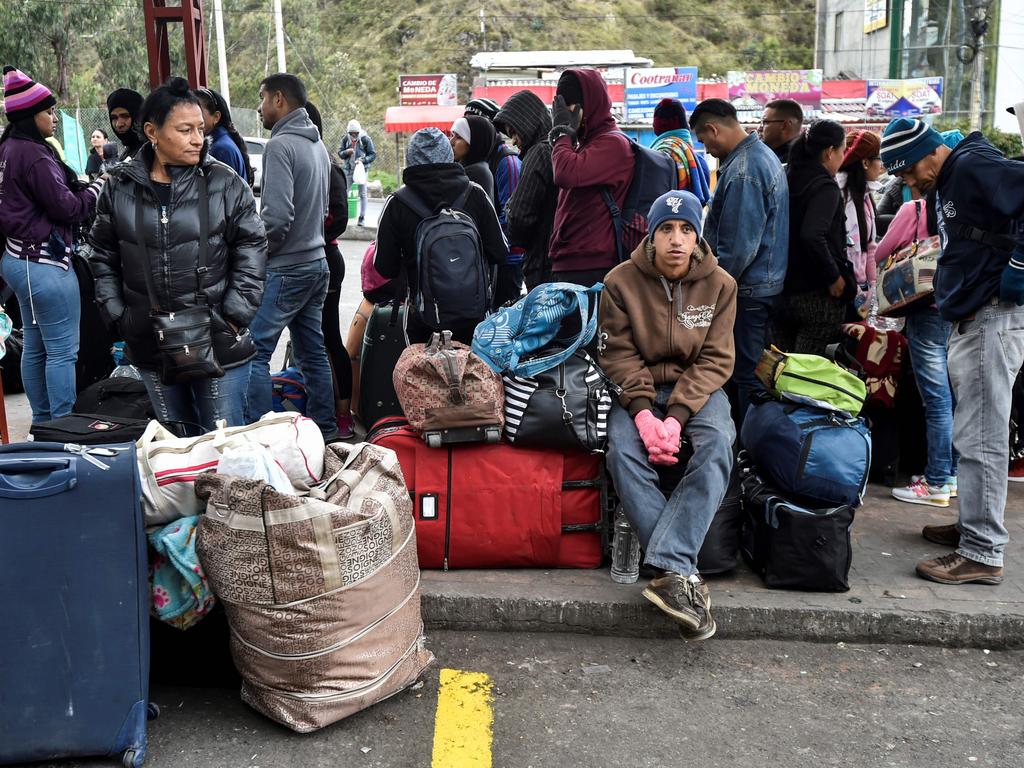 Stranded Venezuelans wait outside the Colombian migrations office near the border with Colombia and Ecuador. Picture: Luis Robayo/AFP