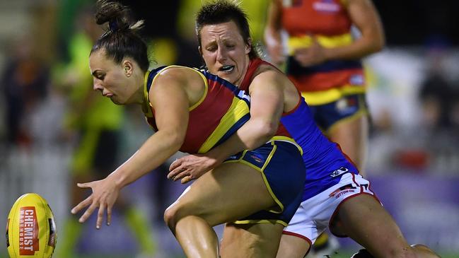 Ebony Marinoff is brought down in a fierce tackle by Karen Paxman, who was instrumental in the Demons’ opening win. Picture: Mark Brake/Getty Images