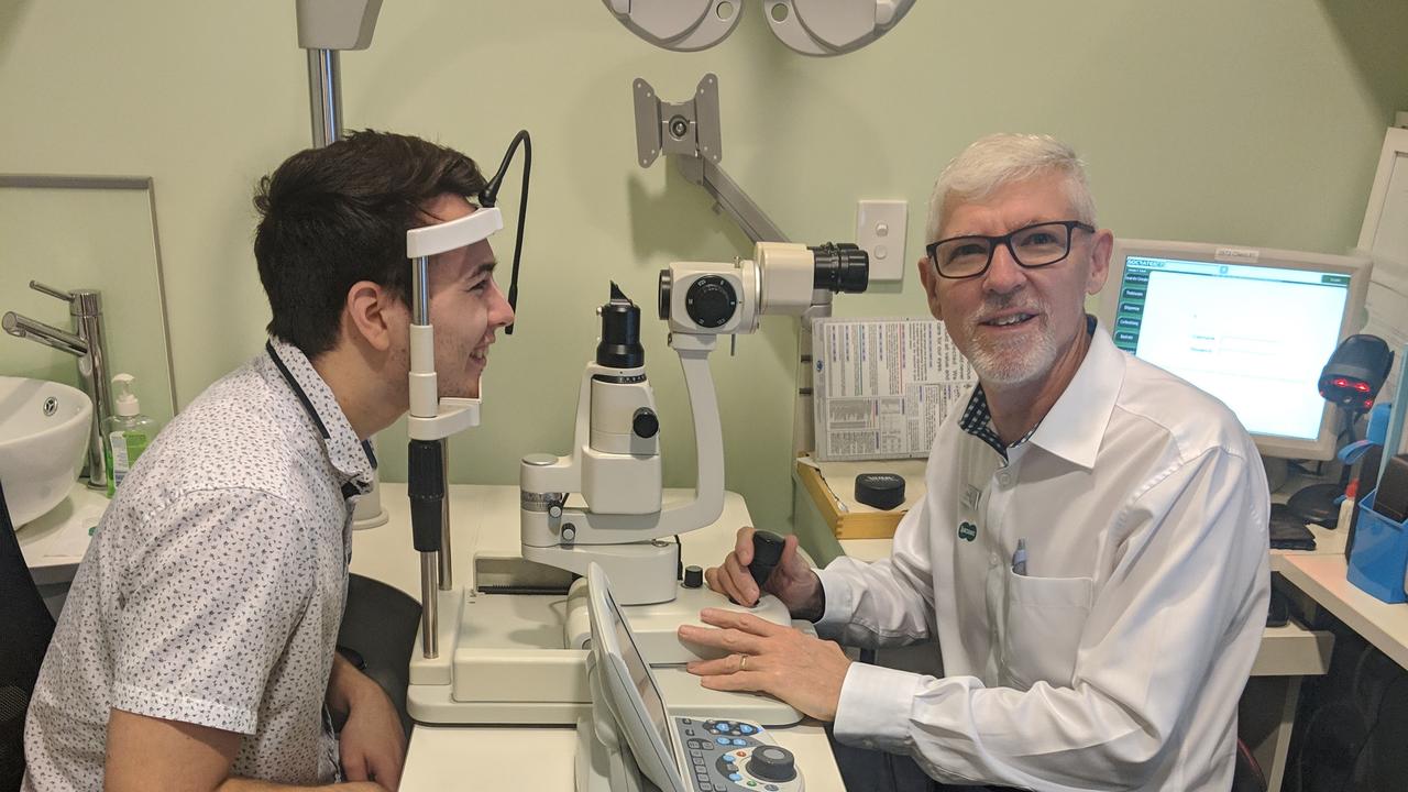 Kieran Davey gets his eyes checked by Specsavers Clifford Gardens optometrist Steve Turley.