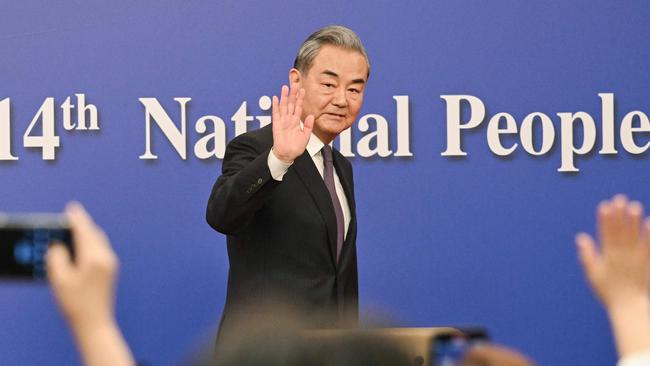 China's Foreign Minister Wang Yi waves as he leaves a press conference during the ongoing National People's Congress in Beijing on Friday. Photo: AFP