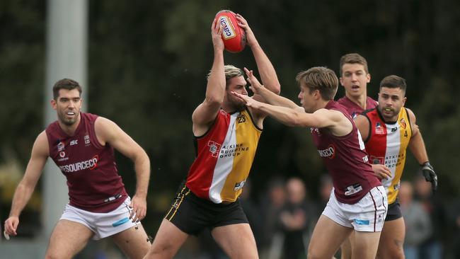 PAOC captain Lachlan McNamara tries to stop Saints Tom Carter. Picture: Dean Martin