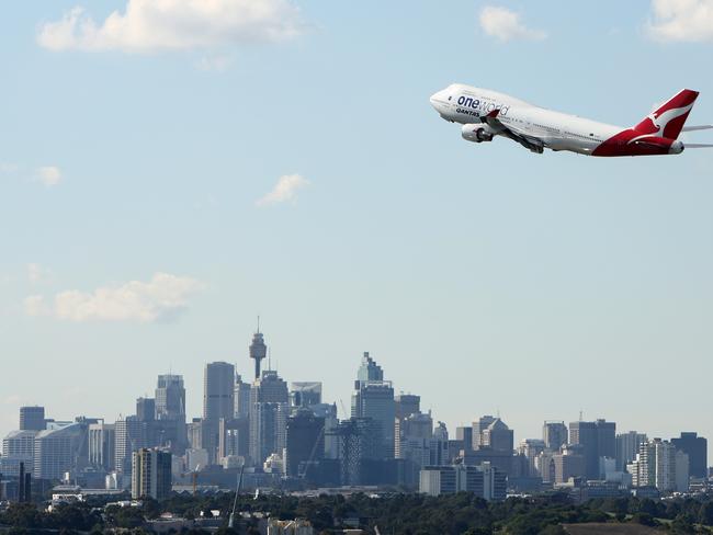 'One World' Qantas 747-400 Takes off from Sydney Airport over Sydney city Picture by Chris Pavlich .