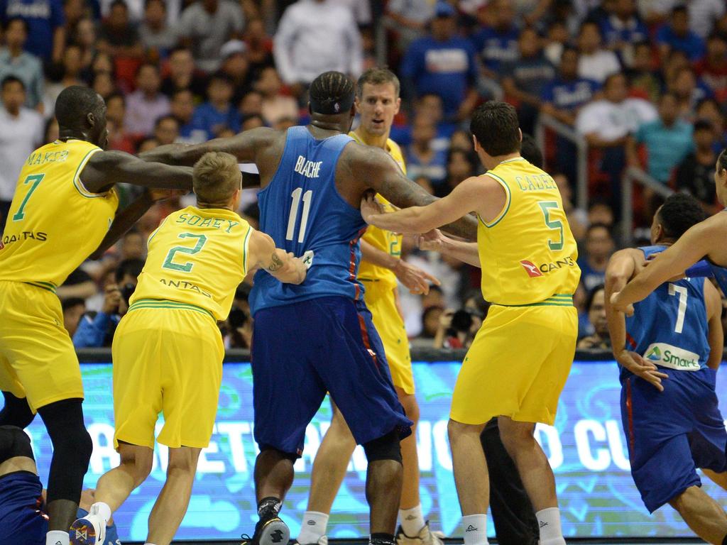 Philippine (blue) and Australian (yellow) players engage in a brawl during their FIBA World Cup Asian qualifier game at the Philippine arena in Bocaue town, Bulacan province, north of Manila on July 2, 2018. Australia won by default 89-53. / AFP PHOTO / TED ALJIBE