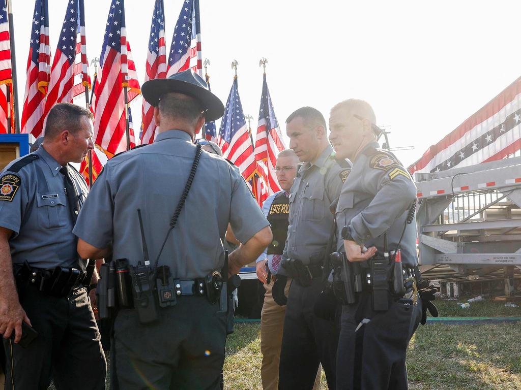 Law enforcement agents stand near the stage of a campaign rally for Donald Trump after the shooting. Picture: Anna Moneymaker/Getty Images/AFP