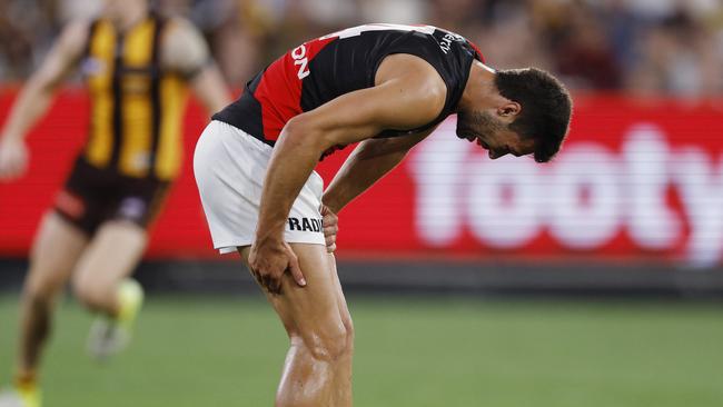 NCA. MELBOURNE, AUSTRALIA. 14th March, 2025 .  AFL  Round 1.  Hawthorn vs Essendon at the MCG.  Kyle Langford of the Bombers grabs at his hamstring after collecting a low ball during the 3rd qtr.    . Picture: Michael Klein