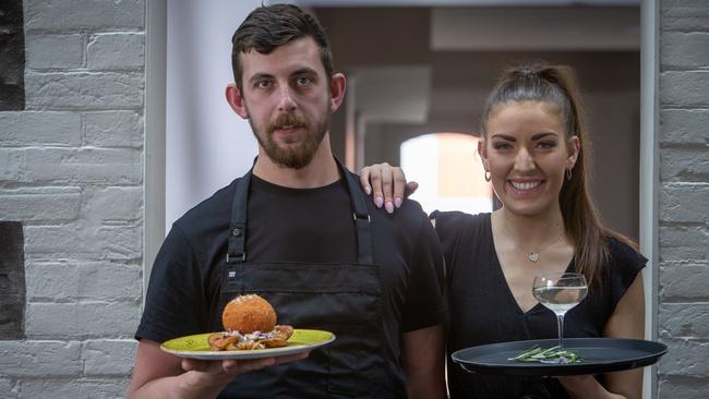 The Brompton’s chef Andrew Wandless with his signature crumbed chicken Kyiv, while duty manager Emmy Thomson holds a martini. Picture: Emma Brasier