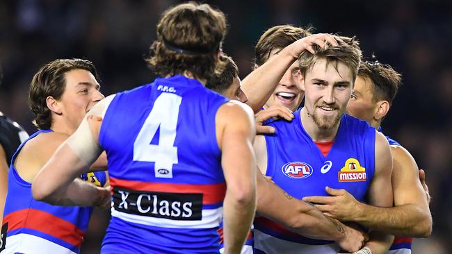 Second-gamer Ryan Gardner is congratulated after kicking a goal for Western Bulldogs. Picture: Quinn Rooney/Getty Images.