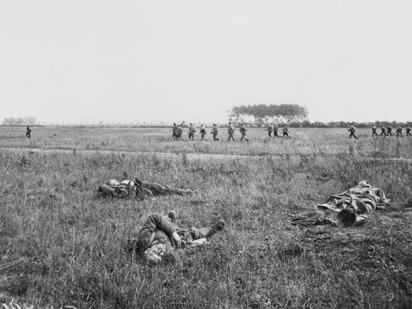 Advancing Australian infantry pass newly captured German trenches near the village of Warfusee-Abancourt. Picture: Australian War Memorial.