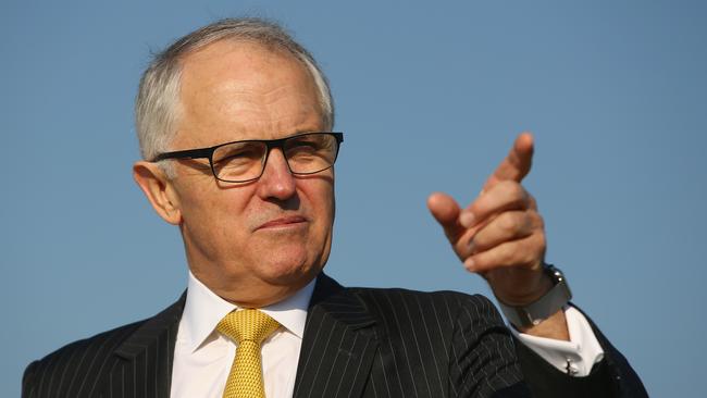 SYDNEY, AUSTRALIA - AUGUST 21: Australian politician Malcolm Turnbull discusses the musicians forming a human wall on a cliff near Macquarie Lighthouse representing standing in the way of suicide to raise awareness for the upcoming Concert For Life on August 21, 2015 in Sydney, Australia. Members of the Sydney Symphony Orchestra lined the cliff to raise awareness of suicide prevention. (Photo by Mark Kolbe/Getty Images)