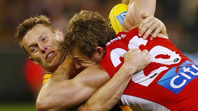 Sam Mitchel wraps up Luke Parker during last year’s clash at the MCG. Picture: Wayne Ludbey