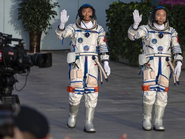 Chinese Shenzhou-16 mission astronaut and first civilian Gui Haichao with mission lead Jing Haipeng at a pre-launch departure ceremony in Jiuquan, China. Picture: Getty Images.