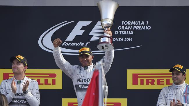 Lewis Hamilton raises the Italian Grand Prix trophy, with teammate Nico Rosberg, left, and Felipe Massa completing the podium.