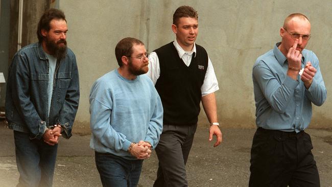 A guard, centre, brings Mark Ray Haydon, left, John Justin Bunting, centre, and Robert Joe Wagner, right, into court.