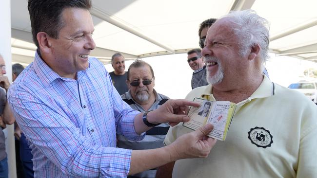 SA Best Leader Nick Xenophon looks at cab record books from taxi driver Barrie South of West Beach during a press conference. Picture: Tracey Nearmy