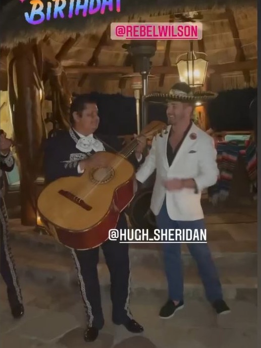 Hugh (right) serenaded Rebel with a Mariachi band.