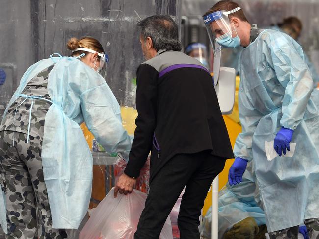 Members of the Australian Defence Force package swab samples ready for testing at a drive-through COVID-19 coronavirus testing station in the Melbourne suburb of Fawkner on July 2, 2020. - Around 300,000 people in Melbourne have to return to lockdown under the threat of fines and arrest as Australiaâs second biggest city attempts to control a spike in virus cases. Health workers went door-to-door in the 36 Melbourne neighbourhoods targeted for lockdown, urging residents to be tested for the coronavirus. (Photo by William WEST / AFP)