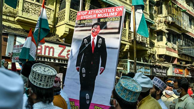 Muslims hold a placard displaying the picture of China's President Xi Jinpingas they protest against the Chinese government's policies on Muslim Uighur minorities, in Mumbai on November 12, 2020. Picture: Punit Paranjpe/AFP